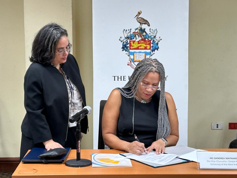 UWI Pro Vice-Chancellor, Global Affairs, Ms. Sandrea Maynard signs the MoU at The UWI’s Regional Headquarters in Jamaica with Legal Officer, Ms. Haydee Gordon looking on.