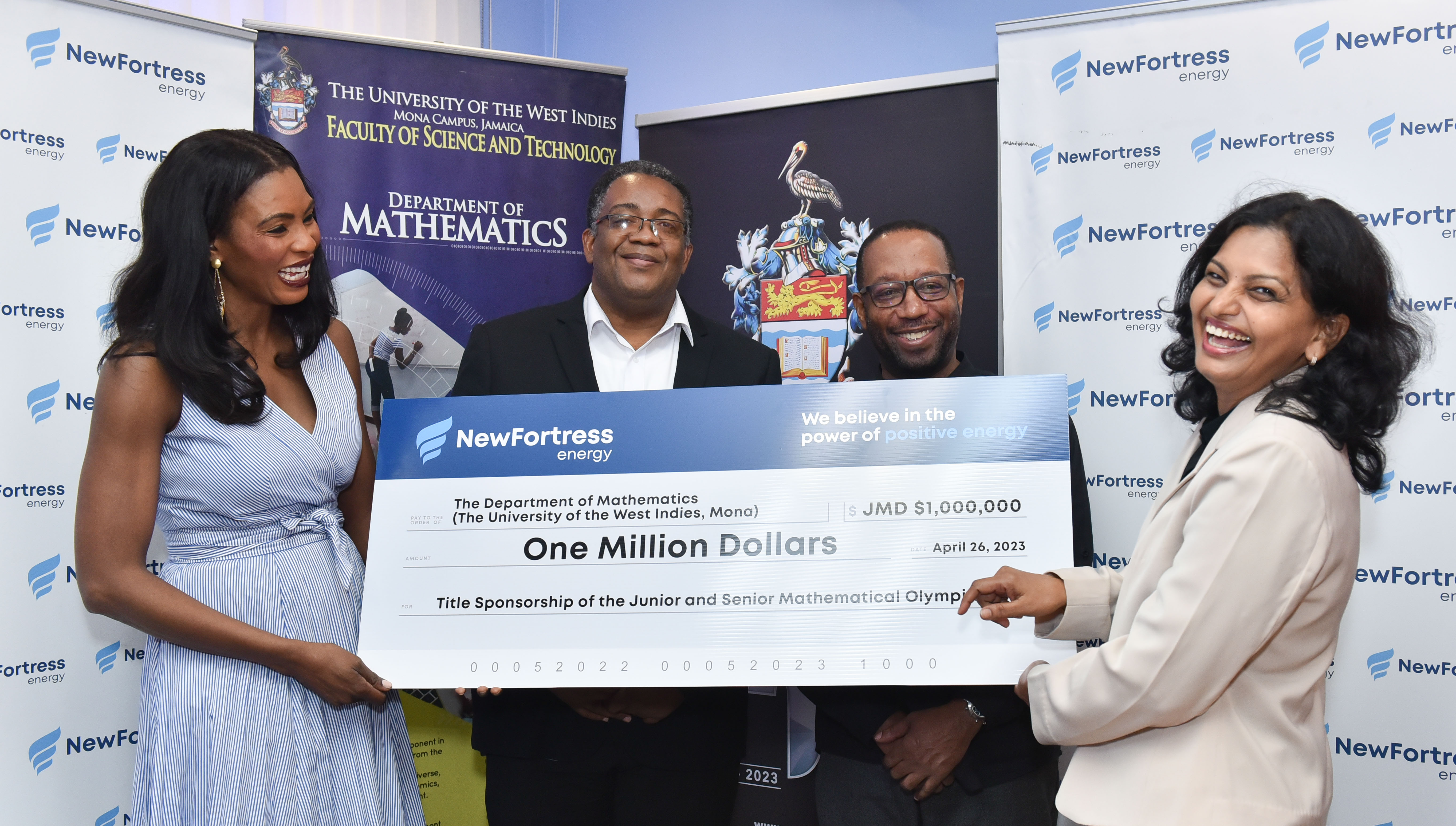 Dr. Nagarani Ponakala (right), Head of the Department of Mathematics happily accepts $1 million (JMD) From Mrs. Verona Carter (left) Vice President of New Fortress Energy.  Dean of the Faculty, Professor Michael Taylor (centre left) and the Deputy Principal of the Mona Campus Professor Ian Boxill (centre right) stand in support. 